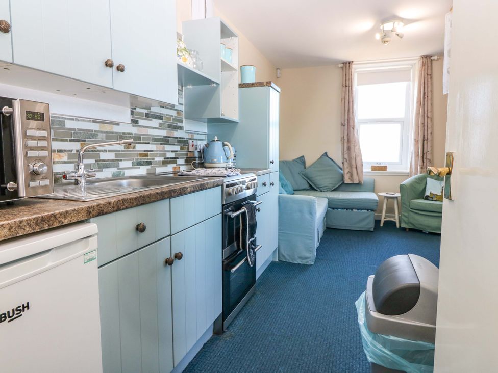 A kitchen with cabinets and appliances at The Flaghouse at The Lighthouse St Abbs
