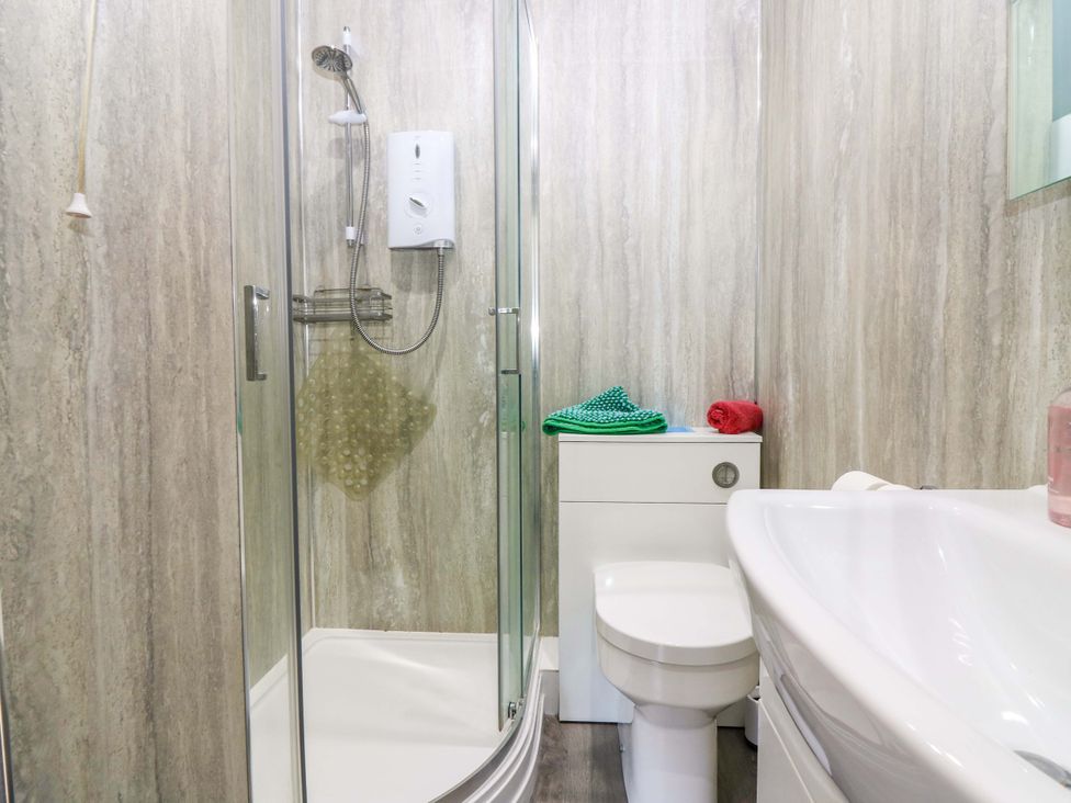 A bathroom with a shower, toilet, and sink at The Flaghouse at The Lighhouse St Abbs