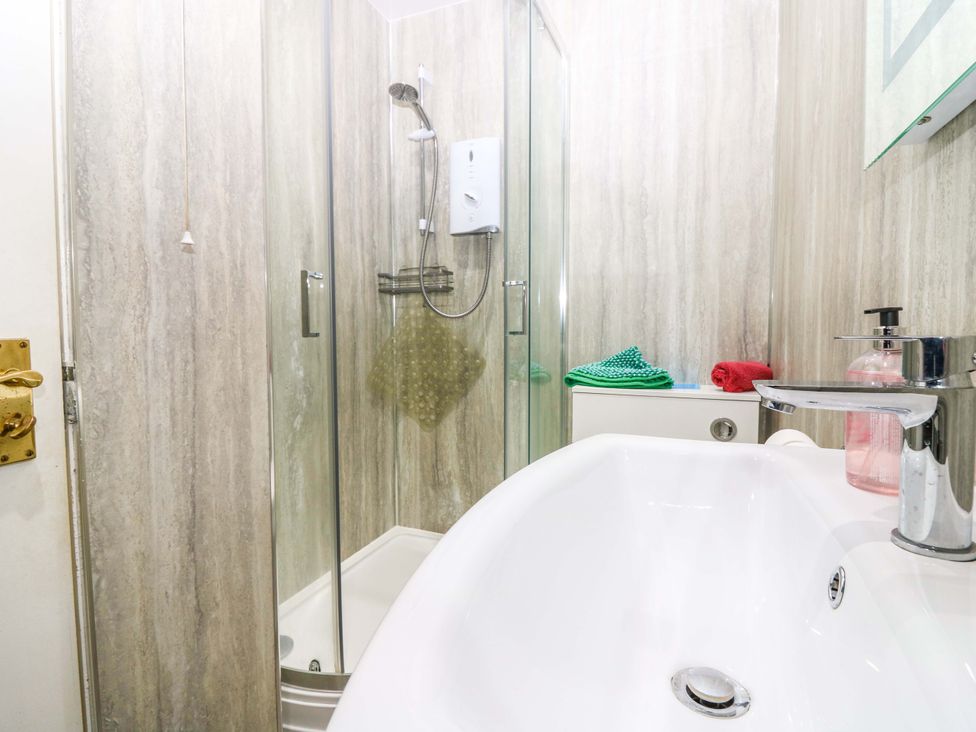 A bathroom with shower and sink at The Flaghouse at The Lighthouse St Abbs