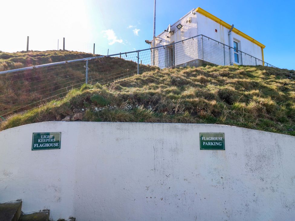 An outdoor view featuring a sign and a building at The Flaghouse at The Lighthouse St Abbs