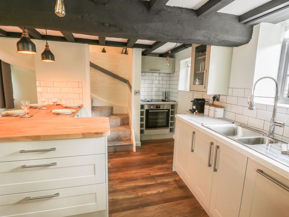 A kitchen with a wooden countertop and appliances at 4 Masons Court in Stratford-upon-Avon