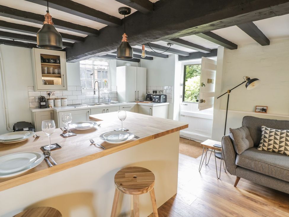 A kitchen with dining table and stools at 4 Masons Court Stratford-upon-Avon