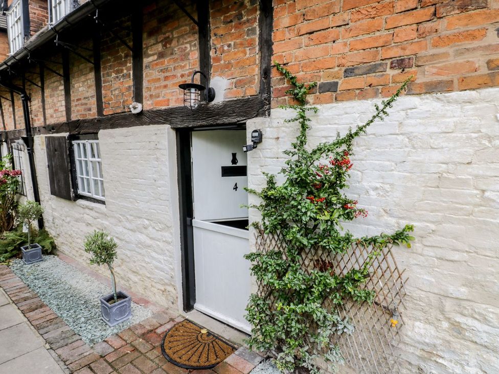 An entrance with a door and plant at 4 Masons Court in Stratford-upon-Avon