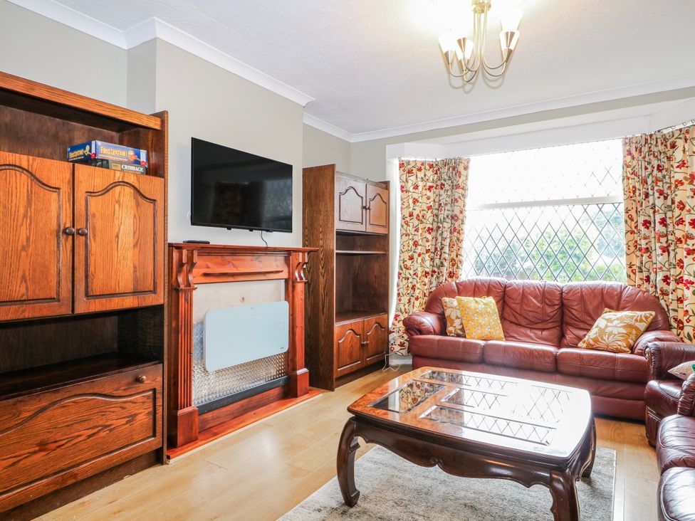 A living room with a sofa and television at The Retreat in Deal