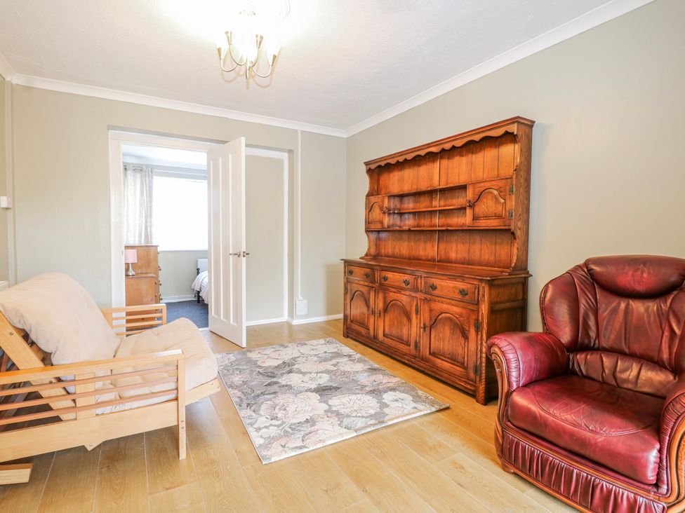 A living room with a sofa and armchair at The Retreat in Deal