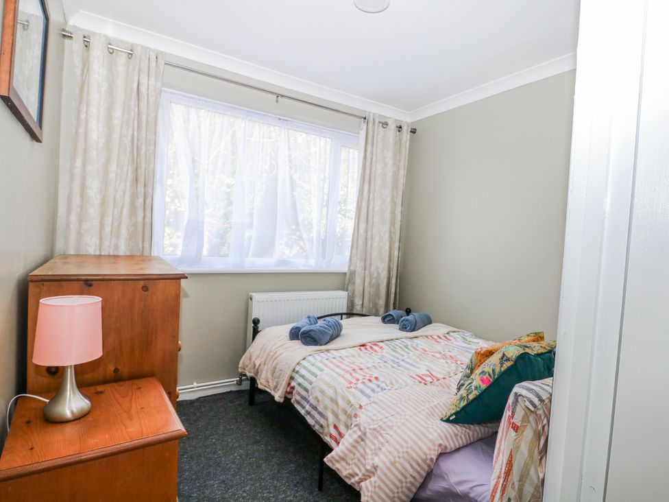 A bedroom with a bed and dresser at The Retreat in Deal