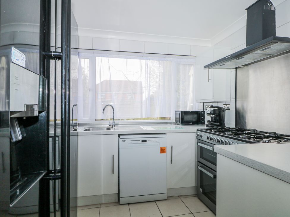 A kitchen with appliances including a refrigerator, dishwasher, and oven at The Retreat in Deal