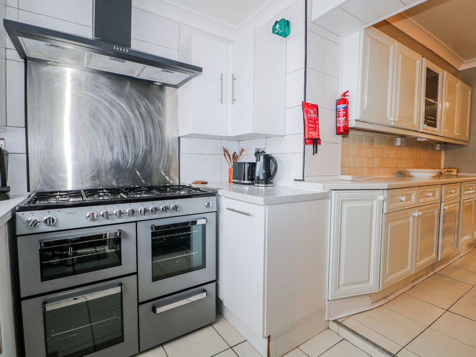 A kitchen with a cooker and kettle at The Retreat in Deal