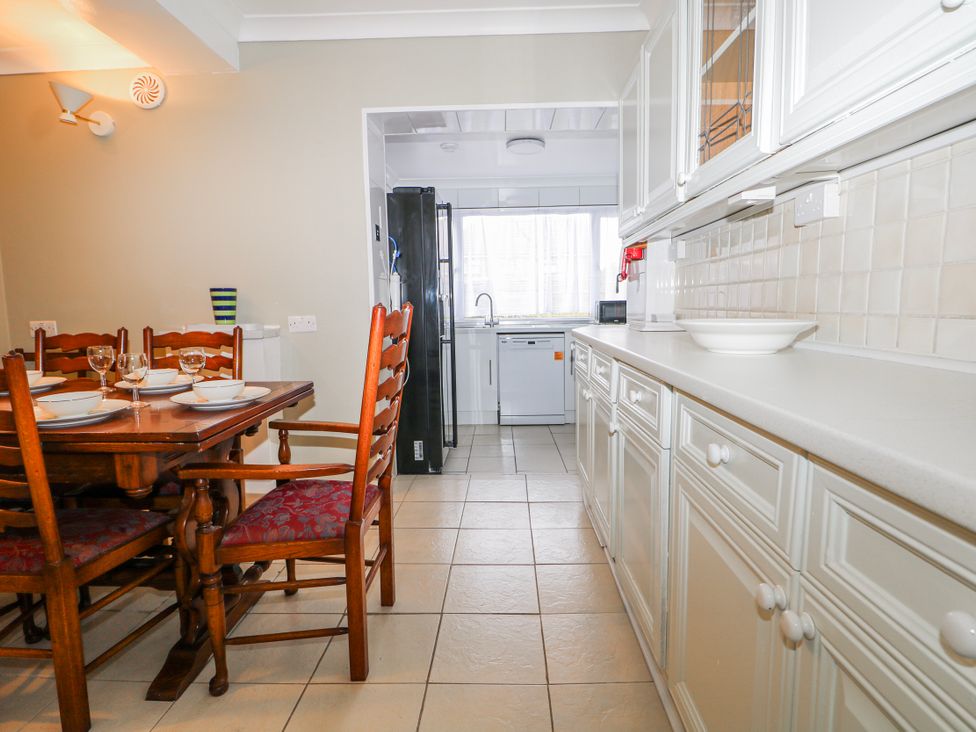 A kitchen with a dining table and chairs at The Retreat in Deal