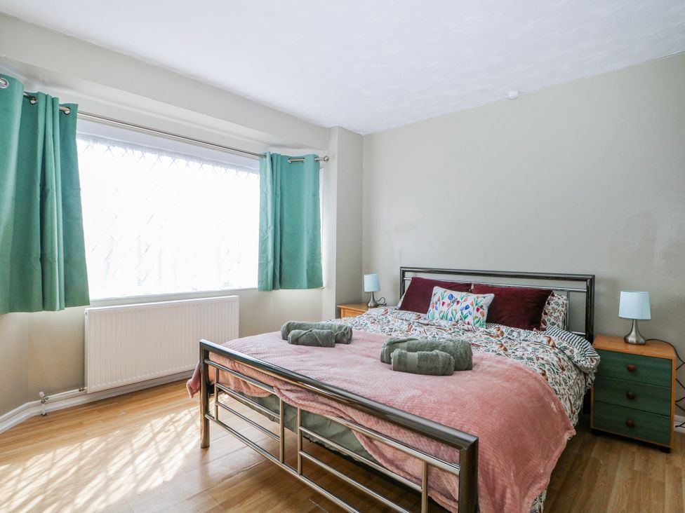 A bedroom with a bed and window at The Retreat in Deal