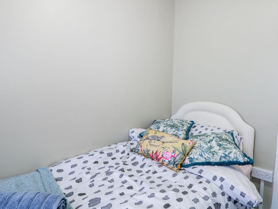 A bedroom with a bed and pillows at The Retreat in Deal