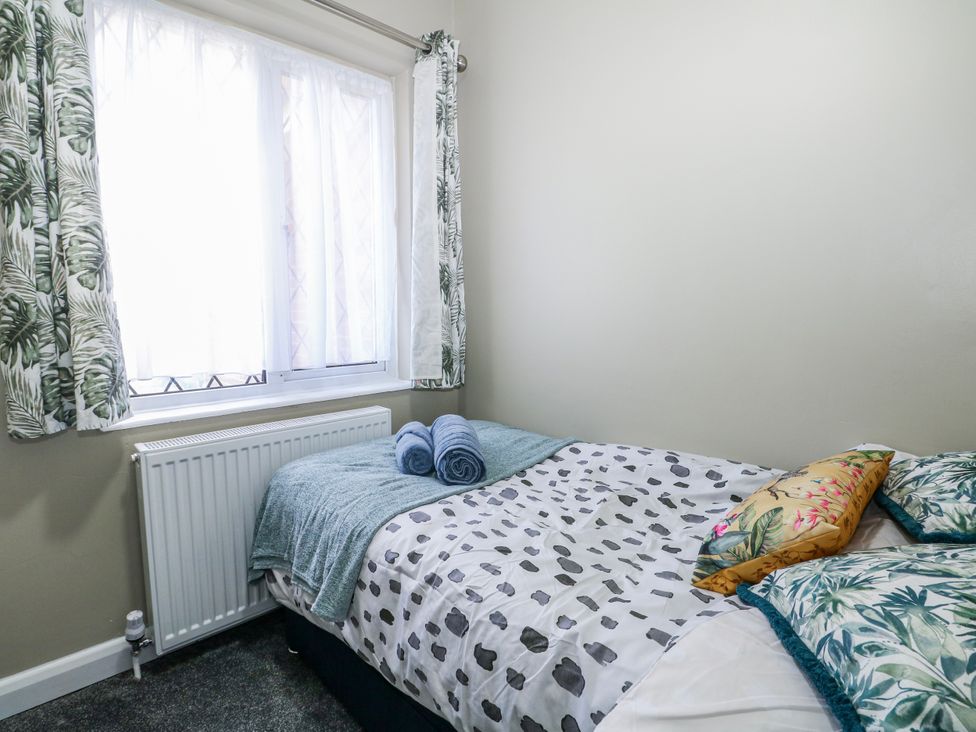 A bedroom with a bed and towels on it at The Retreat in Deal