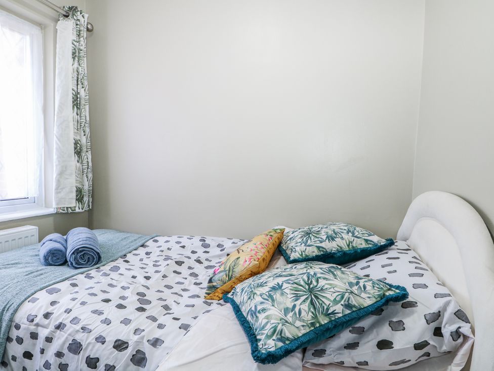 A bedroom with a bed and pillows at The Retreat in Deal