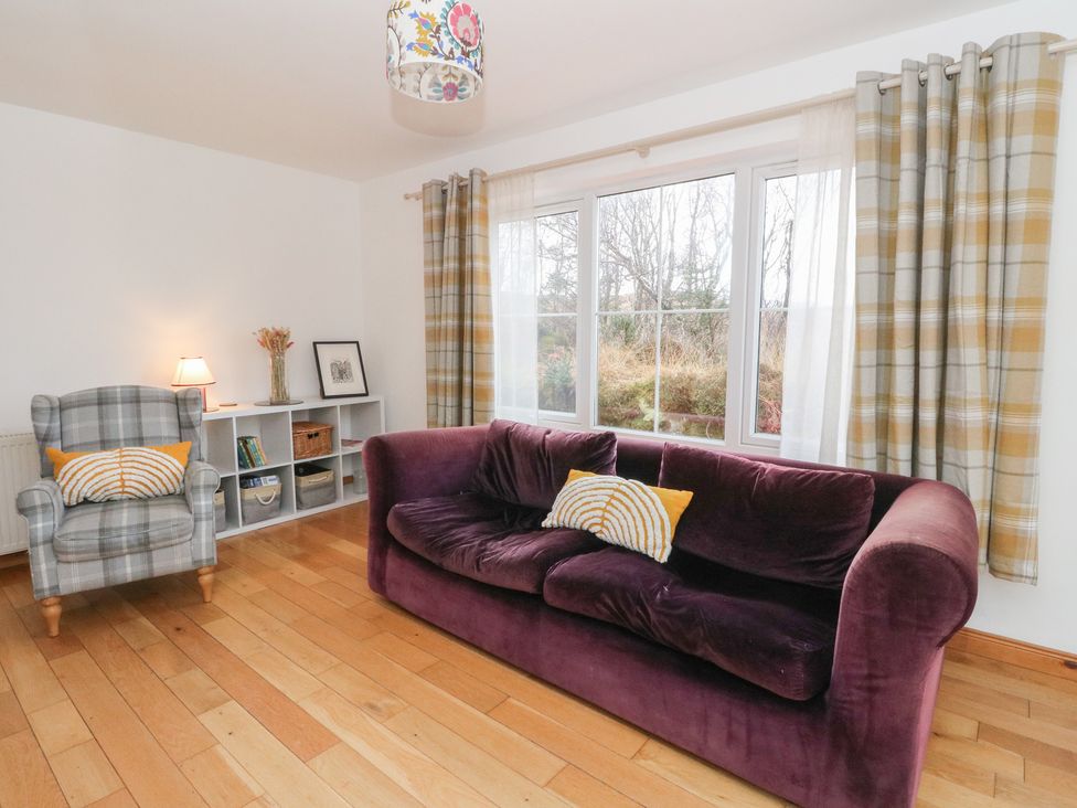 A living room with a sofa and armchair at Doire An Daimh 