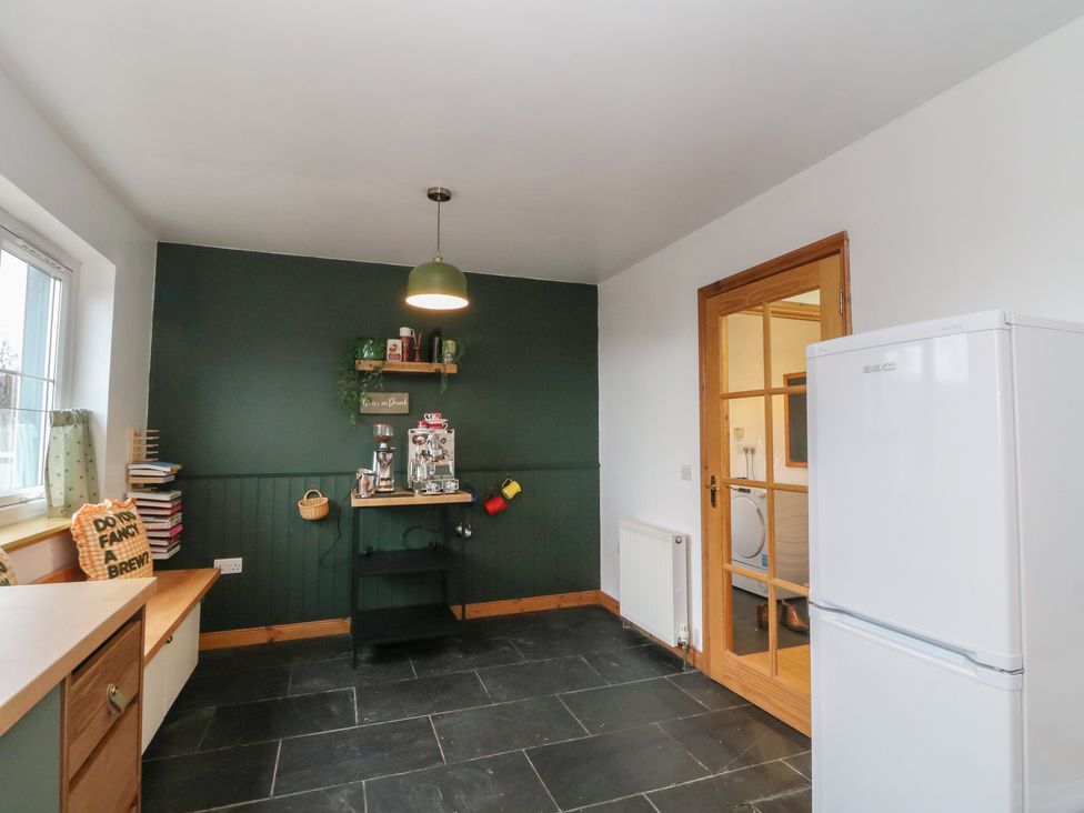 A kitchen with a refrigerator and a shelf at Doire An Daimh