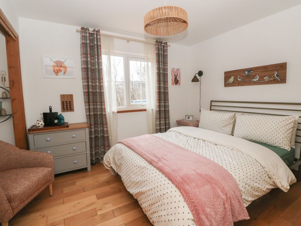 A bedroom with a bed and side tables at Doire An Daimh, 