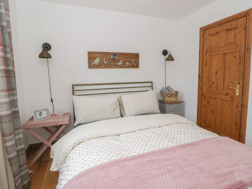 A bedroom with a bed and a bedside table at Doire An Daimh, 