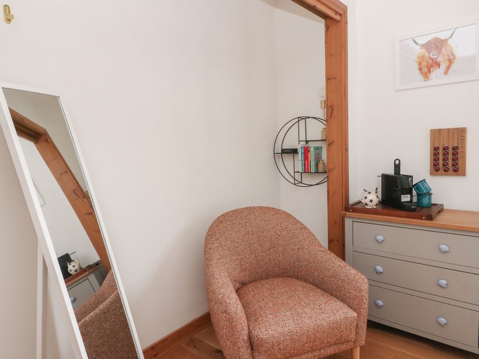An armchair and a mirror in a room at Doire An Daimh