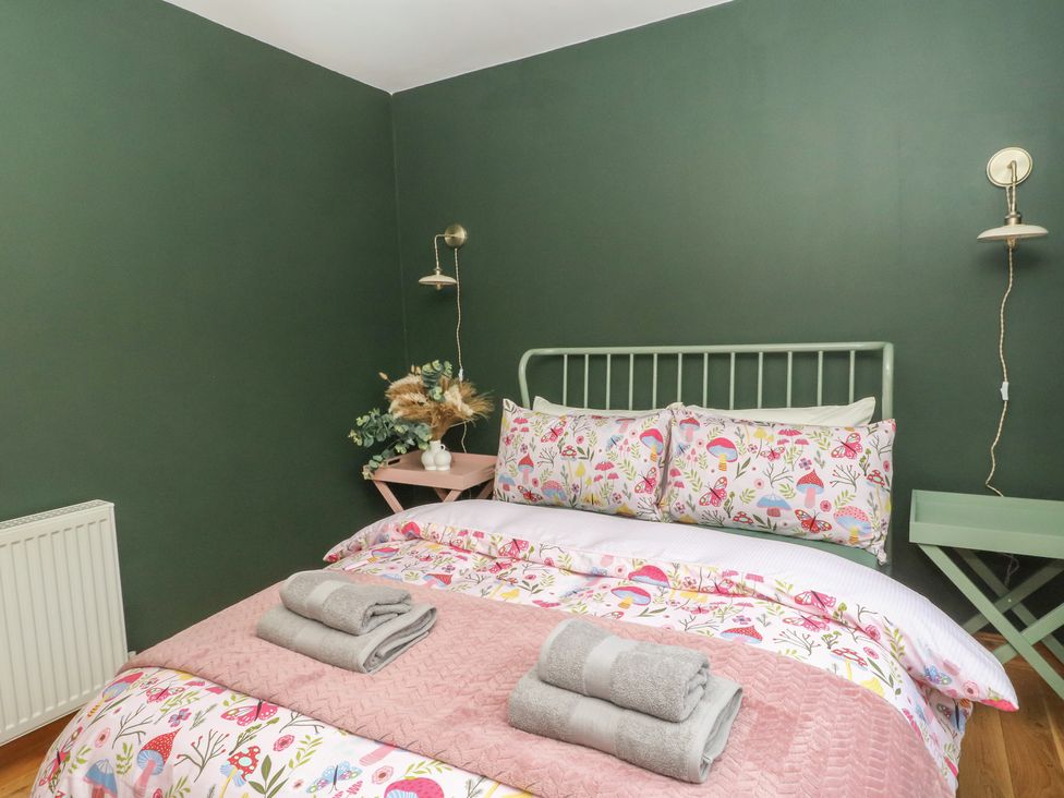 A bedroom with a bed and bedside table at Doire An Daimh
