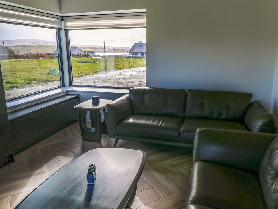 A living room with a sofa and coffee table at An Tobar in Ballina