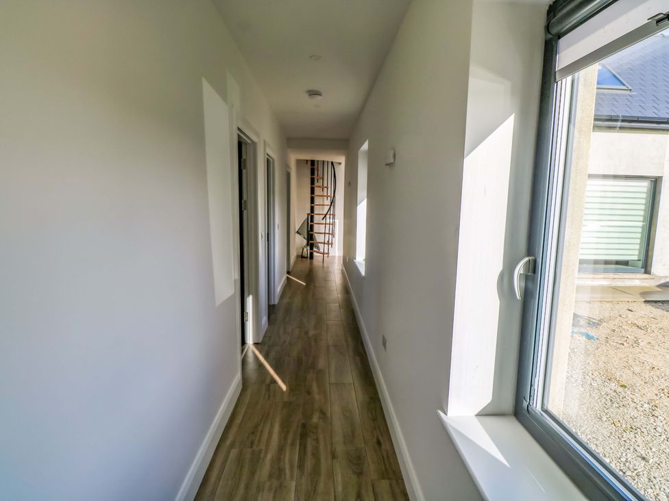 A hallway with doors and staircase at An Tobar in Ballina