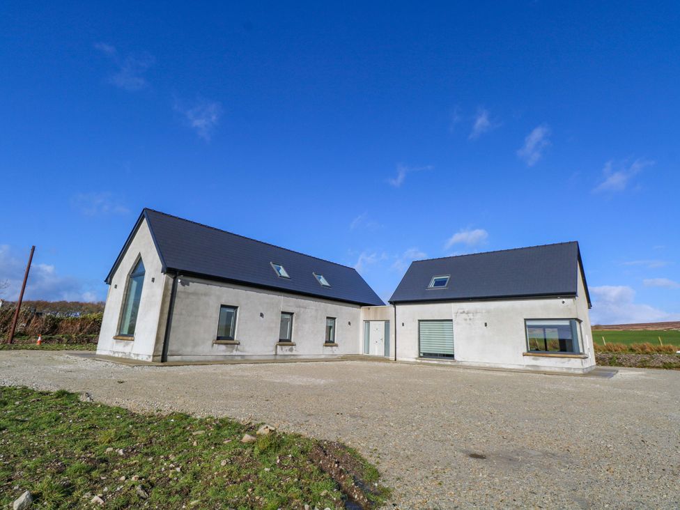 A house with multiple windows and a driveway at An Tobar in Ballina