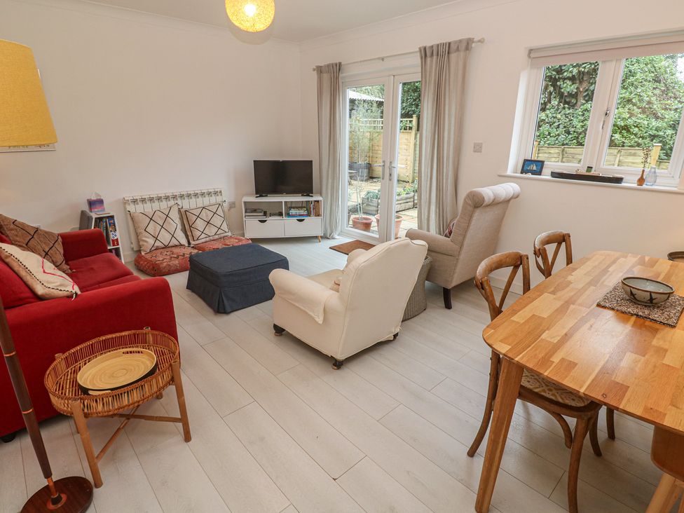 A living room with a sofa and dining table at Pump Cottage in Truro