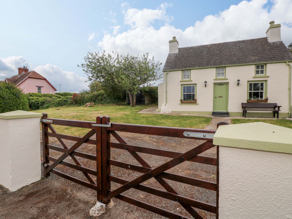 A house with a garden and a wooden gate at Beacon House Marloes near Little Haven