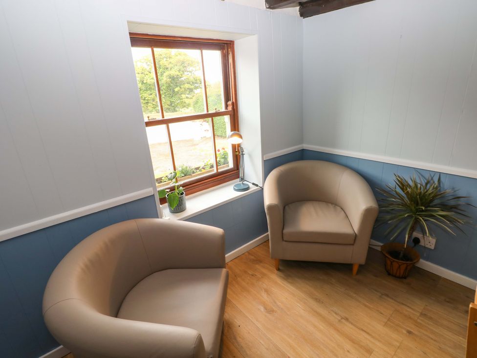 A snug with two armchairs and a lamp at Beacon House in Marloes near Little Haven