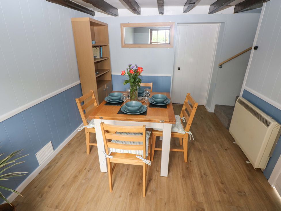 A dining room with a table set for meals at Beacon House Marloes near Little Haven