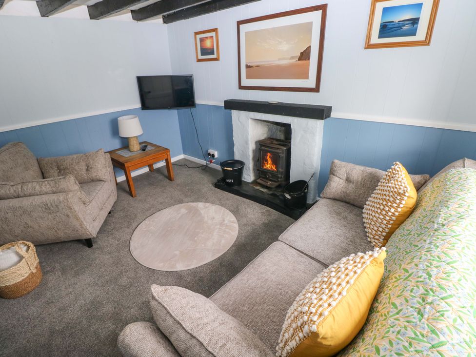 A living room with a sofa and a fireplace at Beacon House Marloes near Little Haven