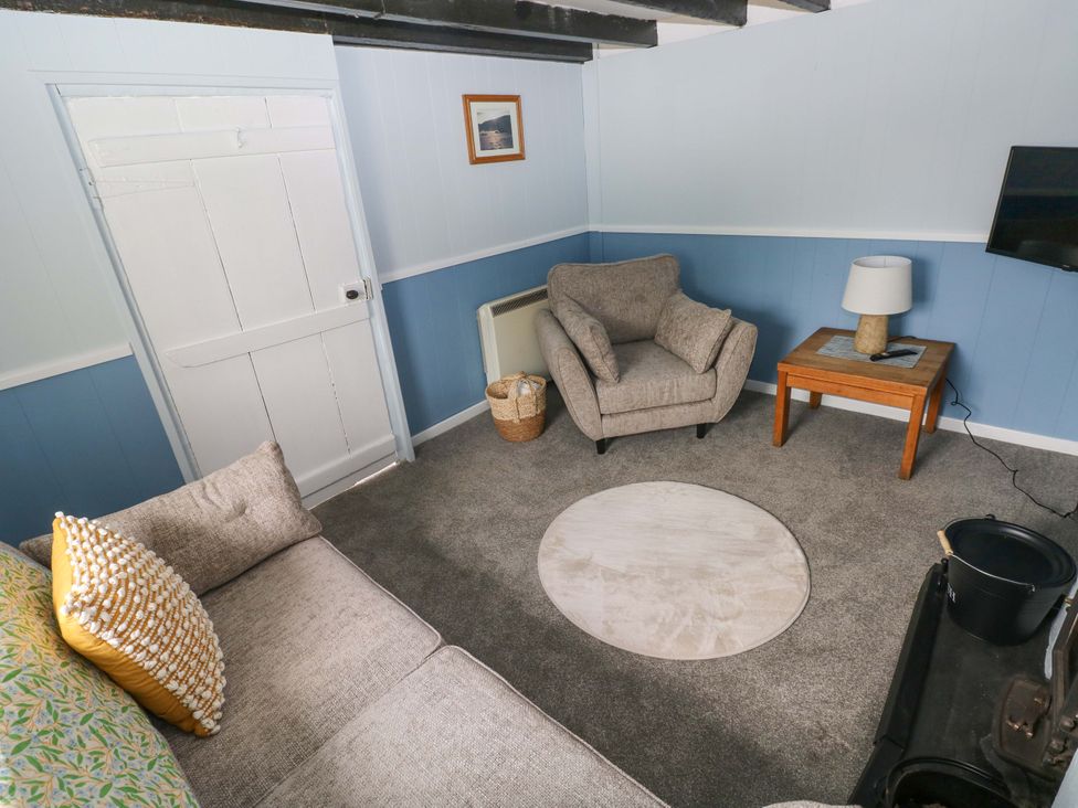 A living room with a sofa and armchair at Beacon House Marloes near Little Haven