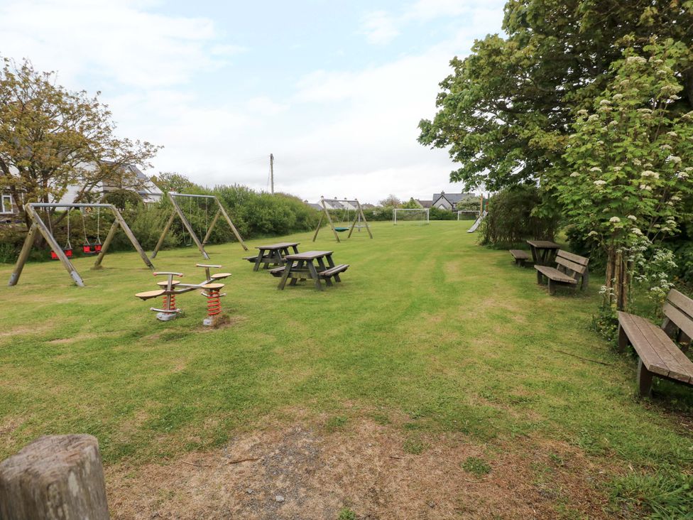 An outdoor area with swings and picnic tables at Beacon House in Marloes near Little Haven