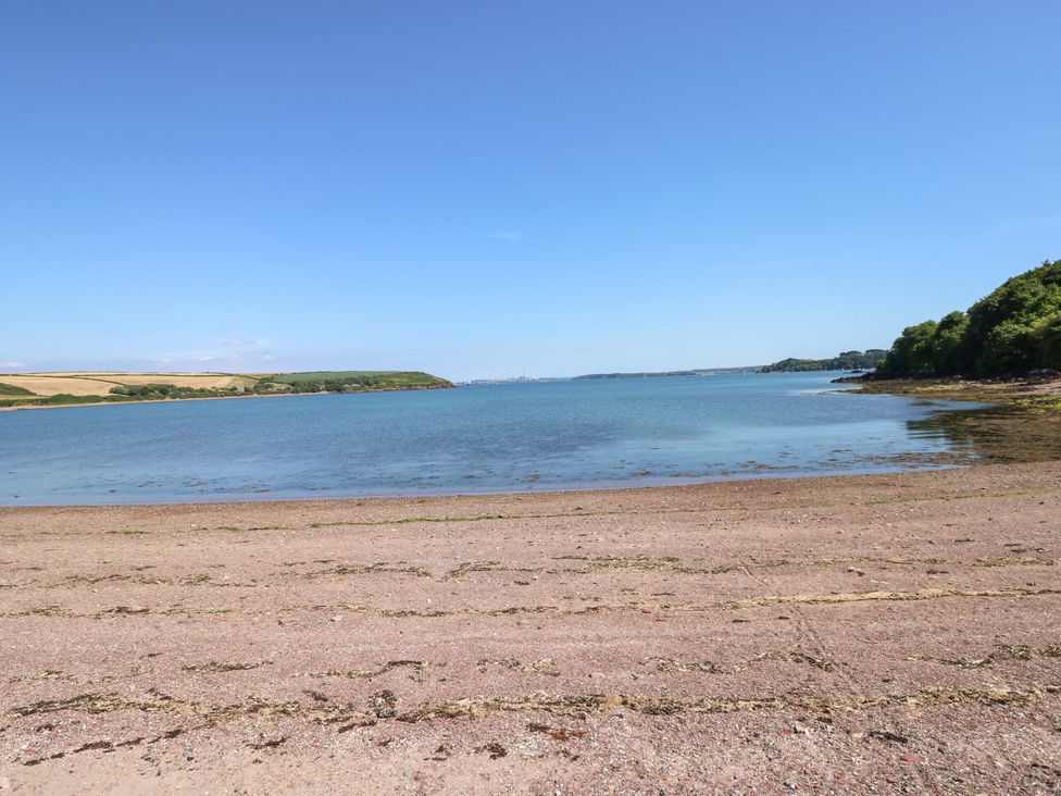 A beach with water and vegetation at Beacon House Marloes near Little Haven