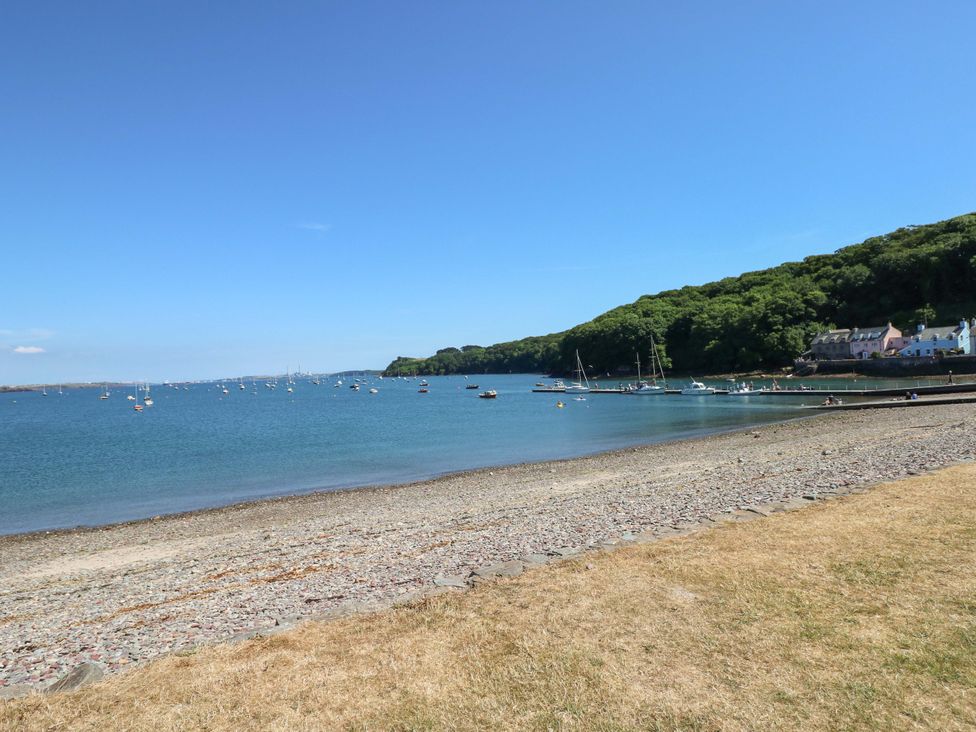 A beach with boats in the water at Beacon House Marloes near Little Haven