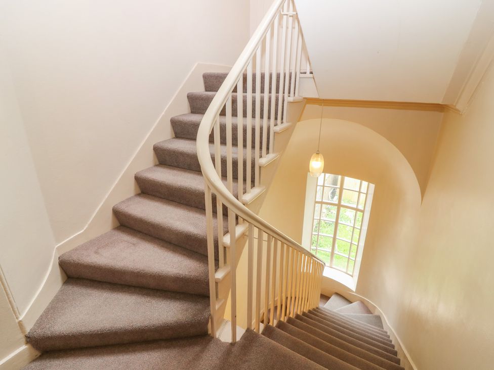 A staircase with carpet and railing at Pincerna Apartment Suite 1a in Aberdeen