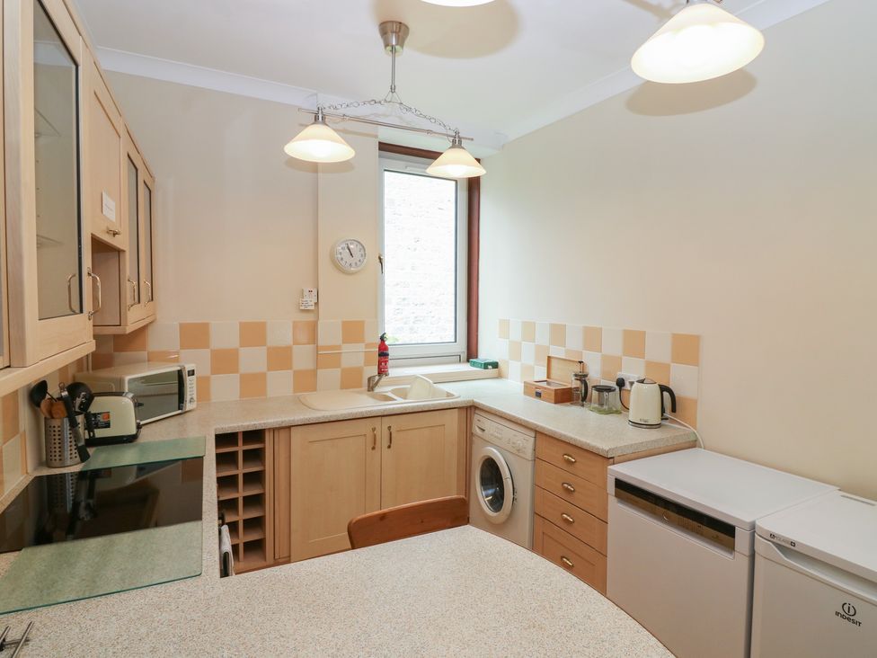 A kitchen with sink, refrigerator, and microwave at Pincerna Apartment Suite 1a Aberdeen
