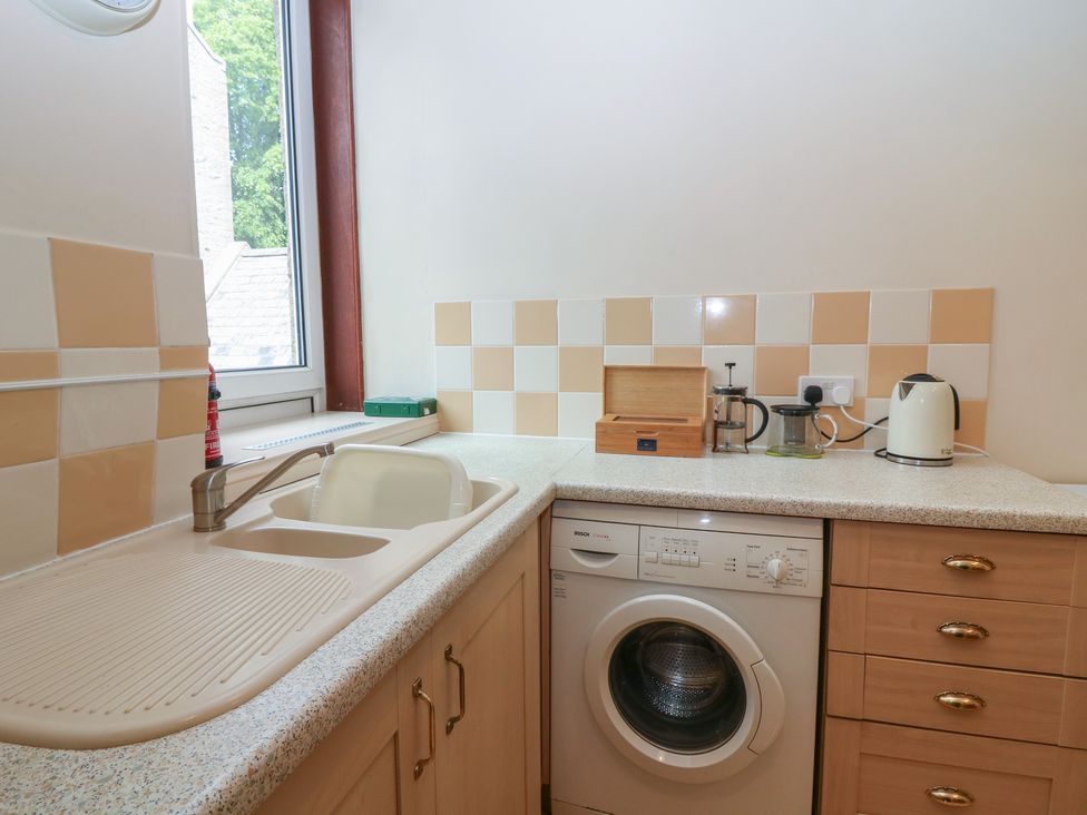 A kitchen featuring a sink and washing machine at Pincerna Apartment Suite 1a Aberdeen