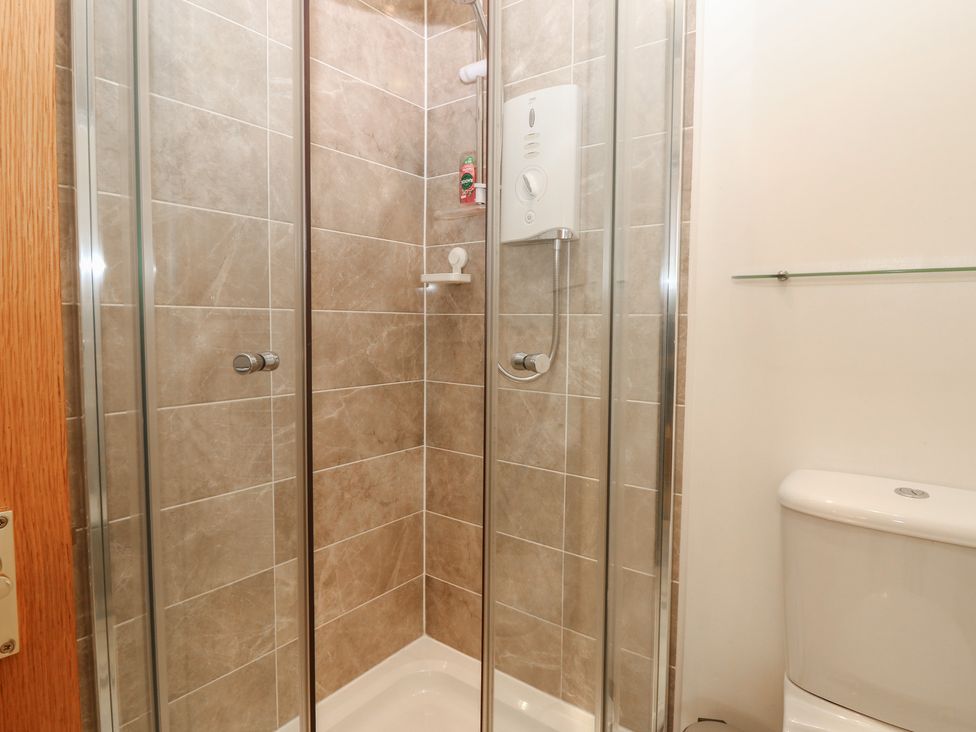 A shower and toilet in a bathroom at Pincerna Apartment Suite 1a Aberdeen