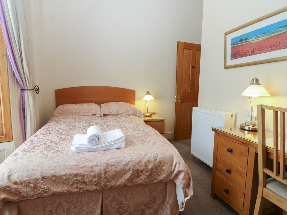 A bedroom with bed and nightstand at Pincerna Apartment Suite 1a Aberdeen