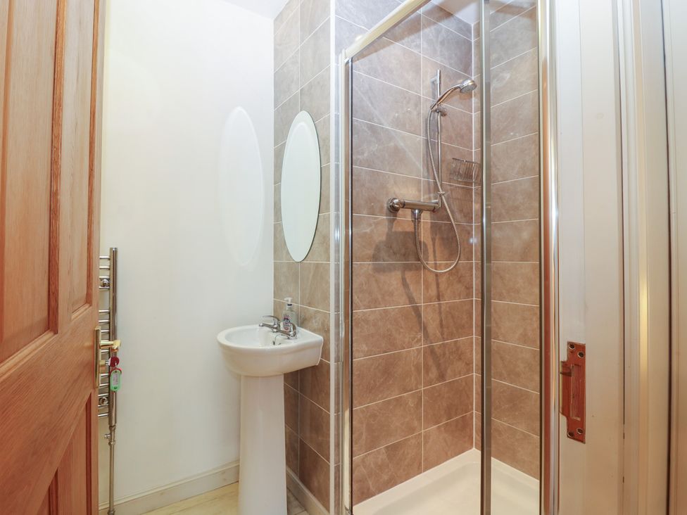 A bathroom with a shower and sink at Pincerna Apartment Suite 1a in Aberdeen