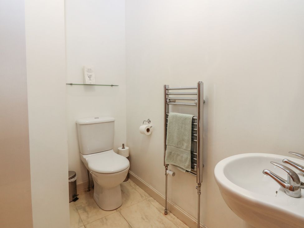 A bathroom with a toilet and hand basin at Pincerna Apartment Suite 1a in Aberdeen