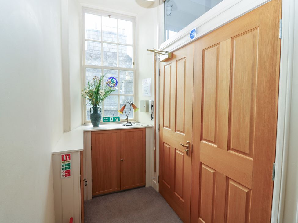 A hallway with doors and a window at Pincerna Apartment Suite 1a in Aberdeen