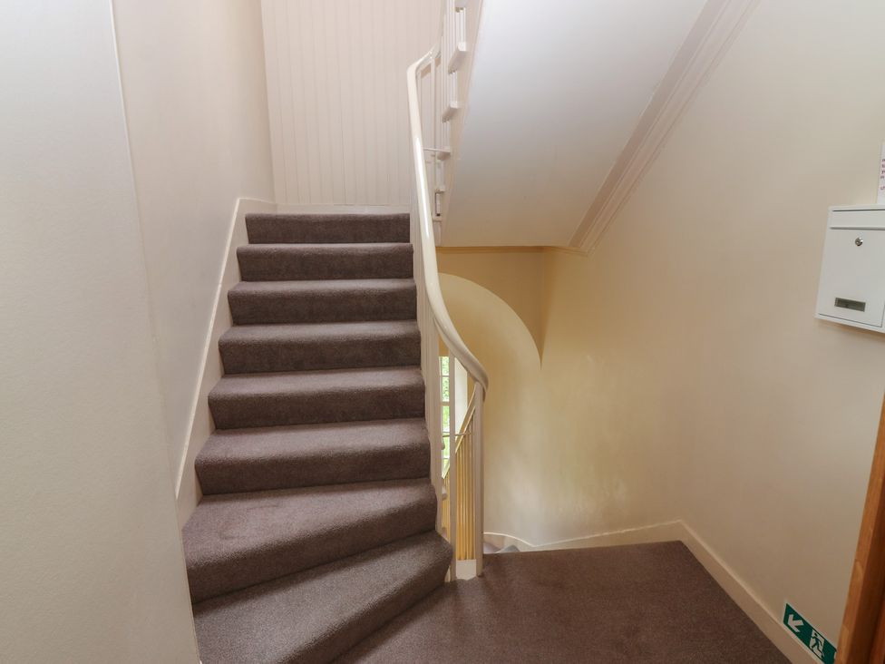 A staircase with a handrail and mailbox at Pincerna Apartment Suite 1a Aberdeen