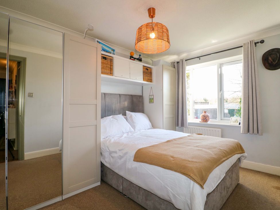 A bedroom with a bed and a window at Flat 16 in Farnham