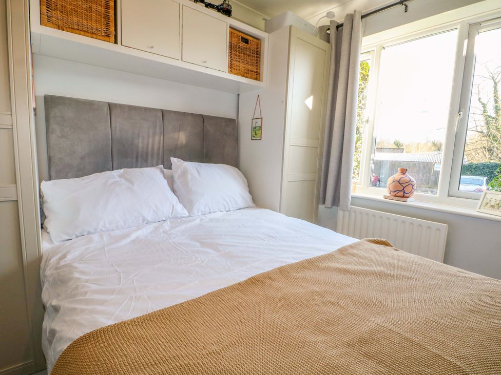 A bedroom with a bed and window at Flat 16 in Farnham