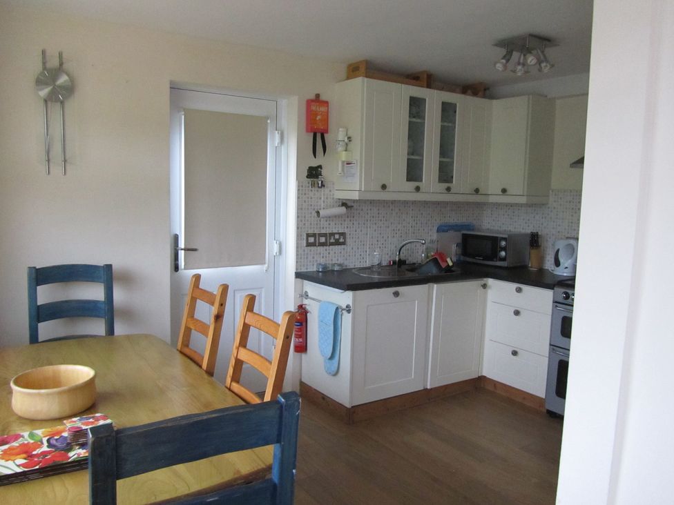 A kitchen with cabinets and appliances at Hope Cove near Kingsbridge