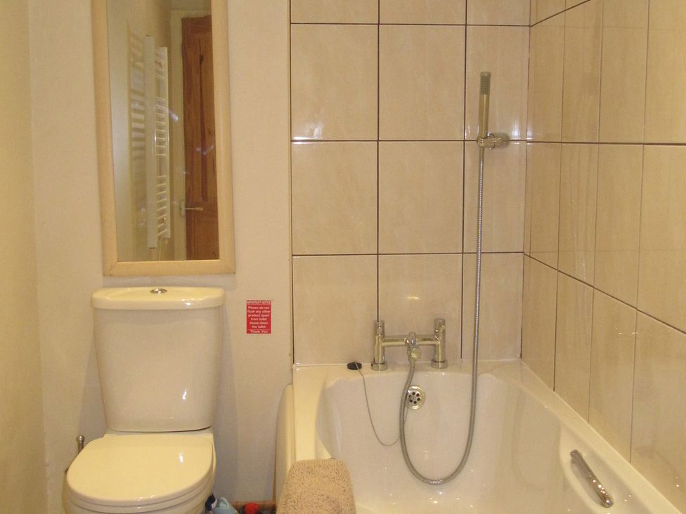 A bathroom with a toilet and a bath at Hope Cove near Kingsbridge