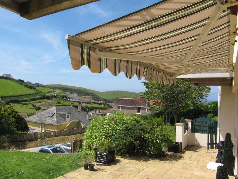 An outdoor area with an awning and view of houses at Hope Cove near Kingsbridge