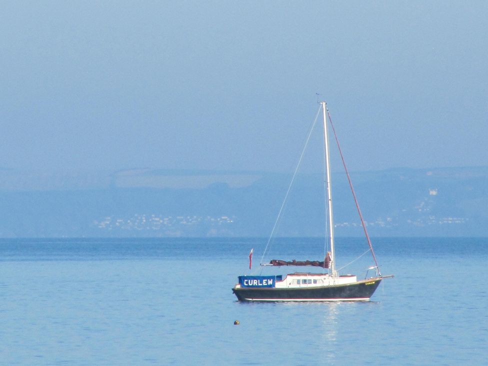 A boat named Curlew on water at Hope Cove near Kingsbridge